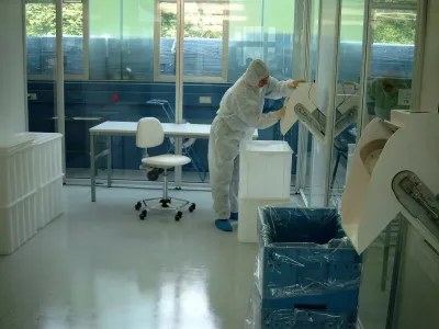 An employee finishing a plastic component by hand.